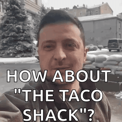 Man Standing In Front Of Sandbags Saying How About The Taco Shack GIF