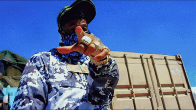 Man Standing In Front Of Shipping Container Number 57000 GIF