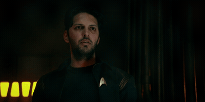 Man Standing In Front Of Sign Saying You're Siding With The Enemy GIF