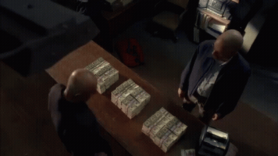 Man Standing In Front Of Stack Of Money GIF
