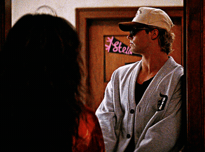 Man Standing In Front Of Stell Sign GIF