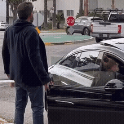 Man Standing In Front Of Stop Sign Next To Car GIF