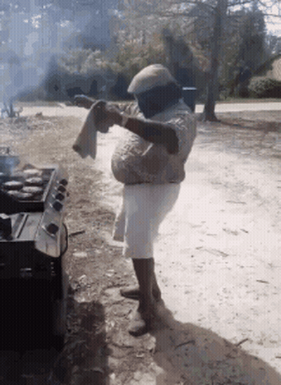 Man Standing In Front Of Stove Holding Towel GIF