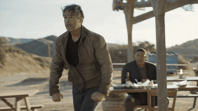 Man Standing In Front Of Table With Alcohol Bottle GIF