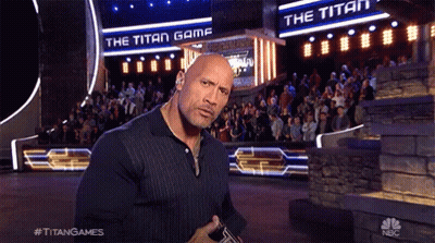 Man Standing In Front Of Titan Game Sign GIF