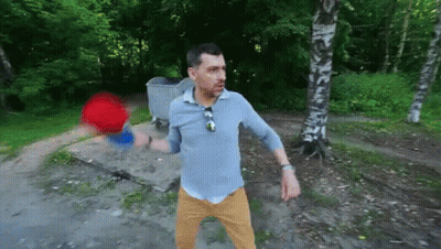 Man Standing In Front Of Trash Can In Woods GIF
