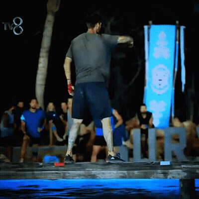 Man Standing In Front Of TV8 Sign GIF