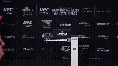 Man Standing In Front Of UFC 333 Sign GIF