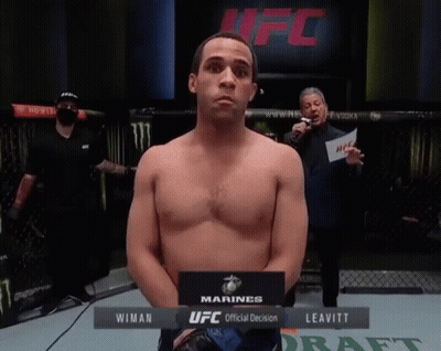 Man Standing In Front Of UFC Official Decision Sign GIF