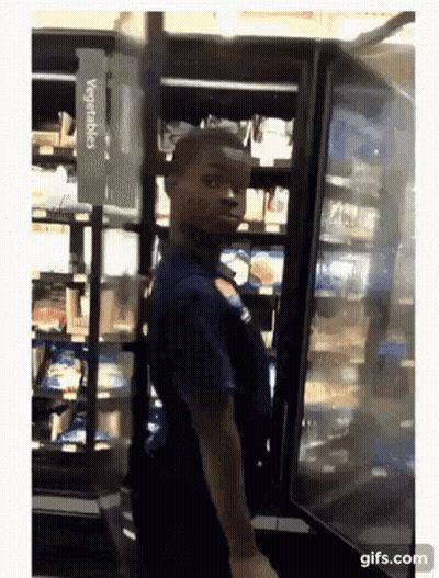 Man Standing In Front Of Vegetables Refrigerator GIF