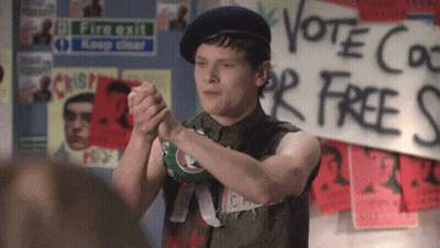 Man Standing In Front Of Vote Co For Free Sign GIF