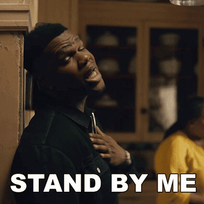 Man Standing In Front Of Wall Saying Stand By Me GIF