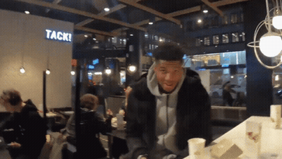 Man Standing In Front Of Wall Saying Tack GIF