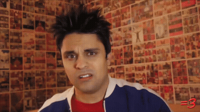 Man Standing In Front Of Wall With Pictures And Number 3 GIF