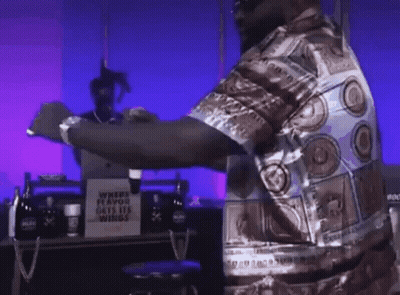 Man Standing In Front Of Where Flavor Gets His Wings Sign GIF