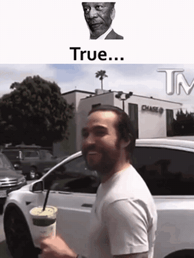 Man Standing In Front Of White Car Holding Coffee GIF
