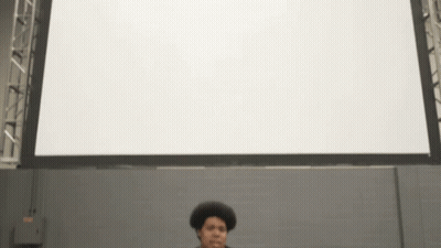 Man Standing In Front Of White Screen GIF
