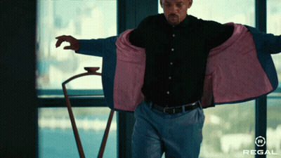 Man Standing In Front Of Window With Regal Logo GIF