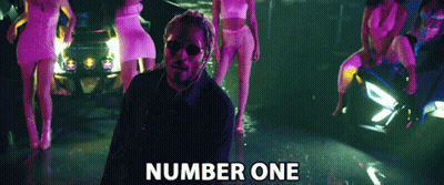 Man Standing In Front Of Women With Number One GIF