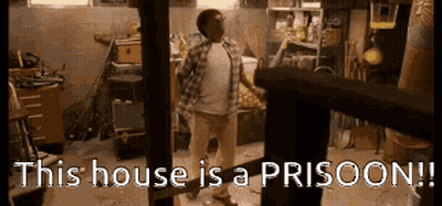 Man Standing In Garage With Prison Sign GIF