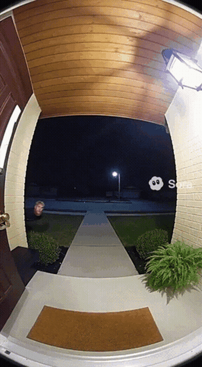 Man Standing In House Doorway At Night GIF