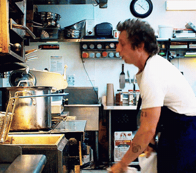 Man Standing In Kitchen With Canola Oil GIF