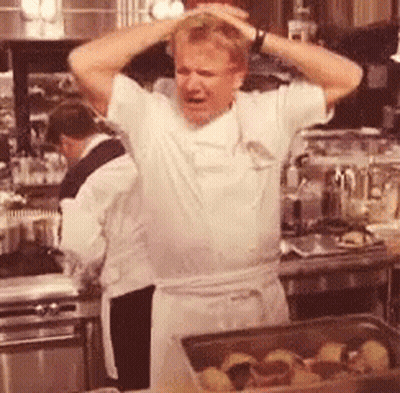 Man Standing In Kitchen With Hands On Head GIF