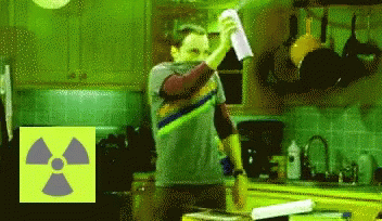 Man Standing In Kitchen With Nuclear Symbol GIF