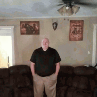 Man Standing In Living Room With Hands In Pockets GIF