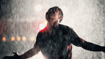 Man Standing In Rain Arms Outstretched Looking Up GIF