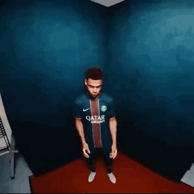 Man Standing in Room With Blue Wall and Red Rug