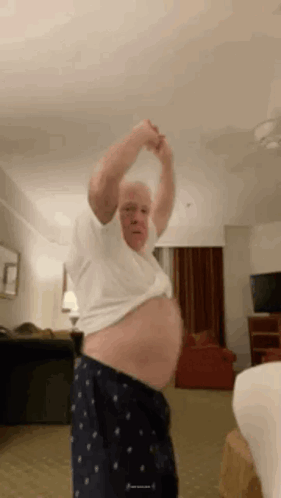 Man Standing In Room With Shirt Off And Belly Exposed GIF