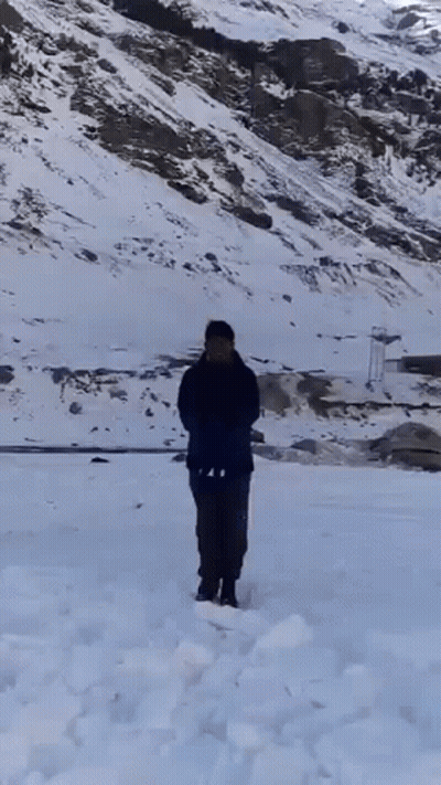 Man Standing In Snow Holding Shovel GIF