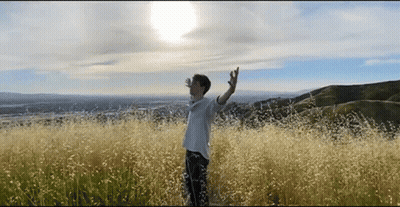 Man Standing In Tall Grass Field GIF