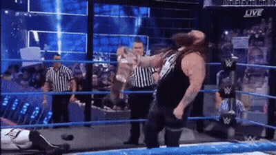 Man Standing In Wrestling Ring With Referee GIF