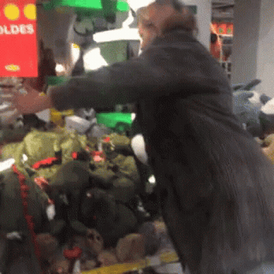 Man Standing Near Stuffed Animals GIF