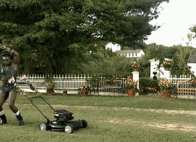 Man Standing Next To Black Lawn Mower GIF