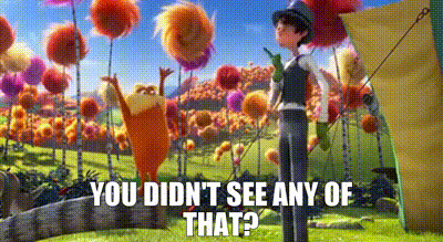 Man Standing Next To Cartoon Character In Flower Field GIF