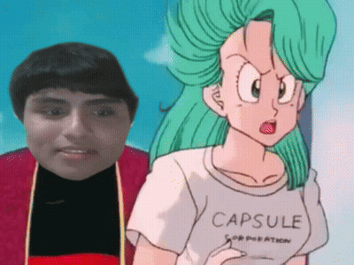 Man Standing Next to Cartoon in Capsule Corporation T-Shirt