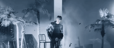 Man Standing Next To Chair With Palm Trees GIF