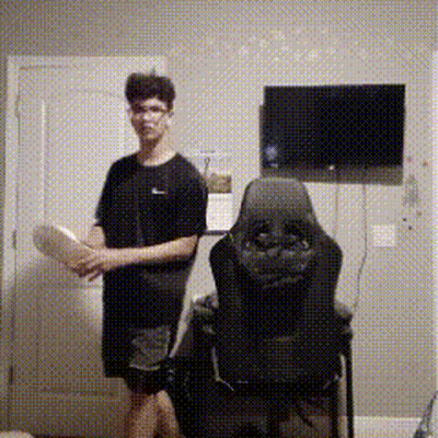 Man Standing Next To Chair With TV GIF