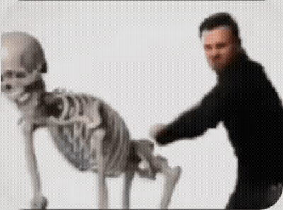 Man Standing Next To Crawling Skeleton GIF