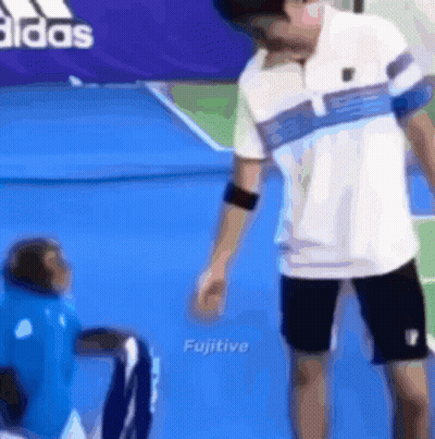 Man Standing Next To Monkey On Tennis Court GIF