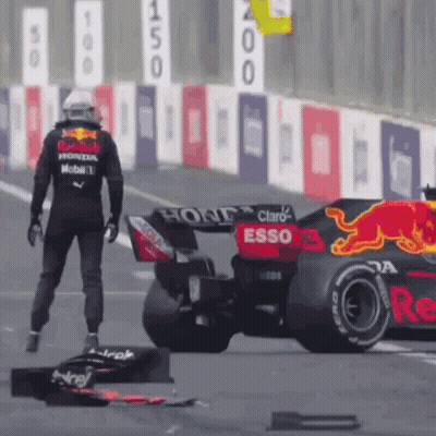 Man Standing Next To Race Car On Track GIF