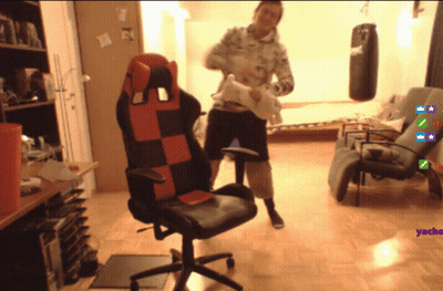 Man Standing Next To Red And Black Chair GIF