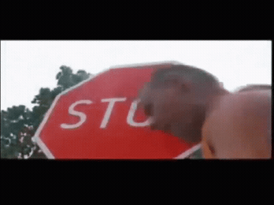 Man Standing Next To Stop Sign GIF