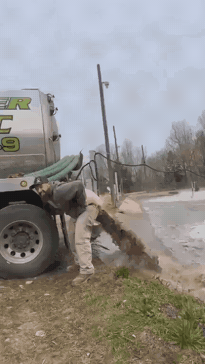 Man Standing Next To Tanker Truck With Number 9 GIF
