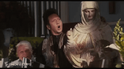 Man Standing Next To Veiled Woman Statue GIF