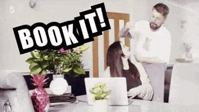 Man Standing Next To Woman At Table With Laptop And Flowers GIF