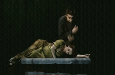 Man Standing Next To Woman Lying GIF